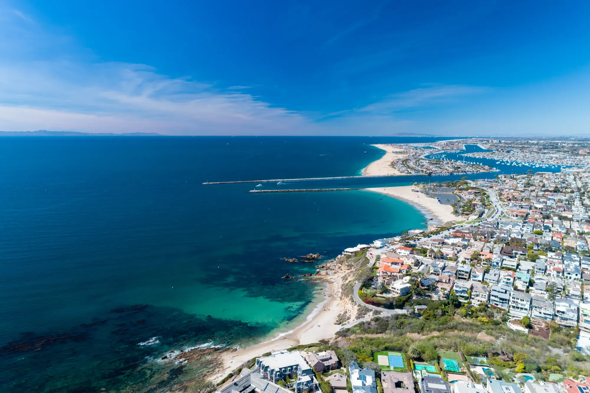 Aerial view of coastal Newport Beach in Orange County, California, USA with coast, sand and blue skies